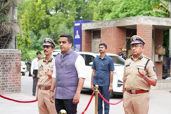 Narasimha Komar in uniform with senior officers and a dignitary during an official inspection outside a government building.